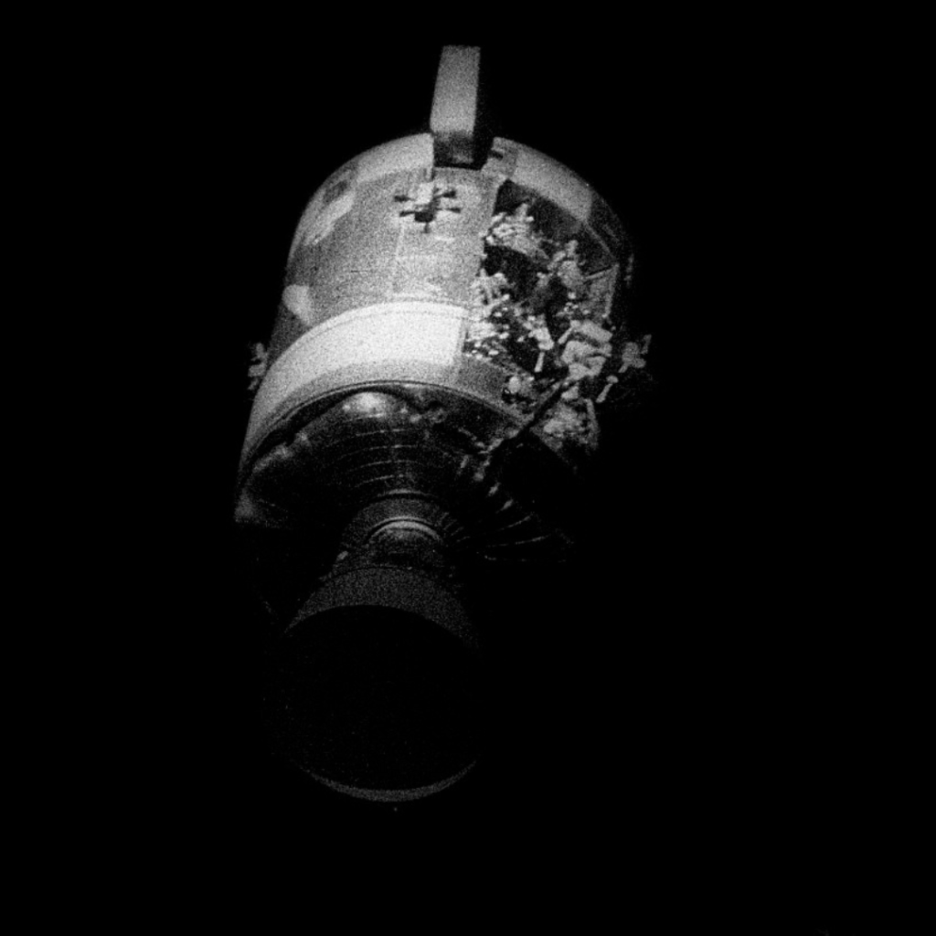 View of the severely damaged Service Module after separation. 17 April 1970. Scan by Kipp Teague.