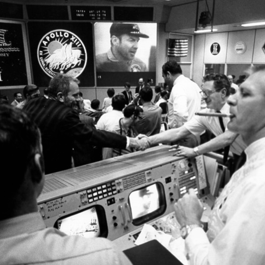 Mission Control in Houston celebrates the safe return of the Apollo 13 crew. Gene Kranz is smoking a celebratory cigar at the right while Deke Slayton, in front of the mission patch, shakes hands. 17 April 1970. Scan by Kipp Teague. 70-H-652 ( 186k or 1288k )
