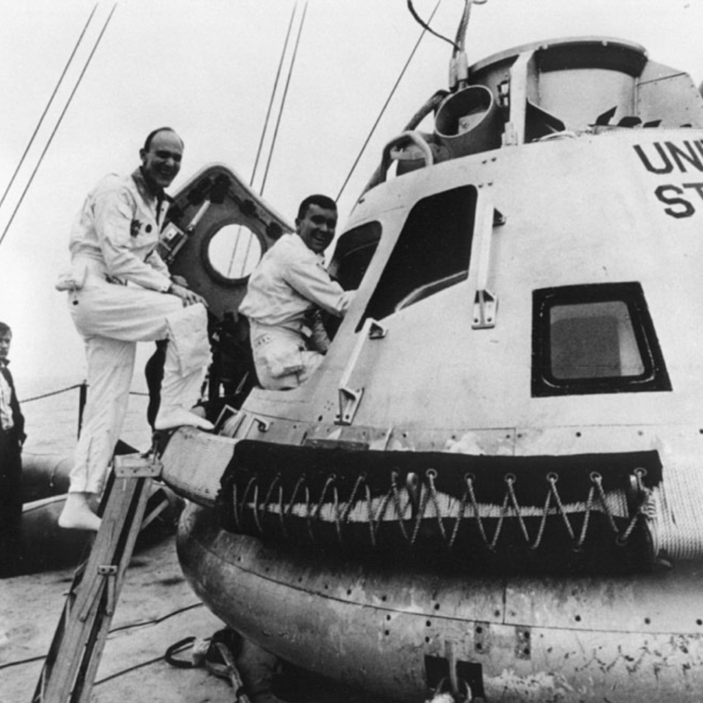 Jim Lovell (left), Ken Mattingly, and Fred Haise climb into a Command Module mock-up for egress training in the Gulf of Mexico. Photo filed 24 February 1970. Scan by Ed Hengeveld.