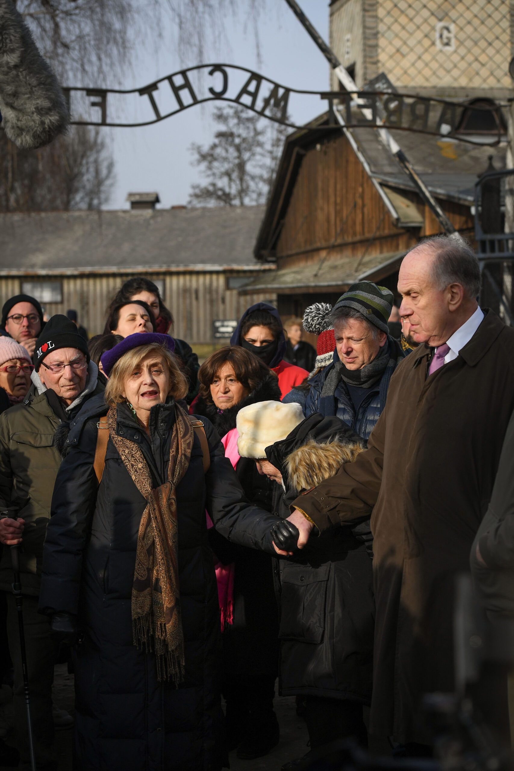 Tova attends the 75th anniversary of the Liberation of Auschwitz and is seen here surrounded by survivors and holding hands with Ronald Lauder, the President of the World Jewish Congress.