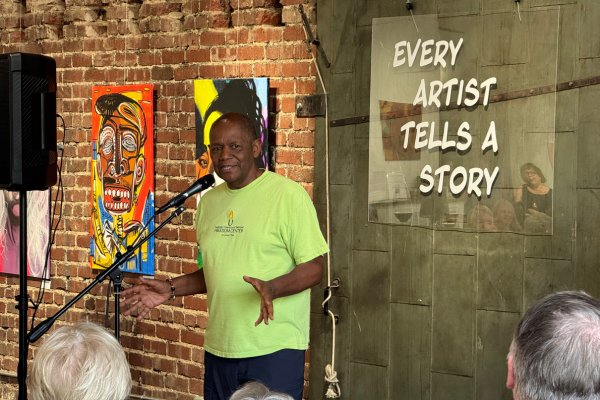 Storyteller Bobby Norfolk telling a tale in front of am audience at local gallery, fishman art gsllery