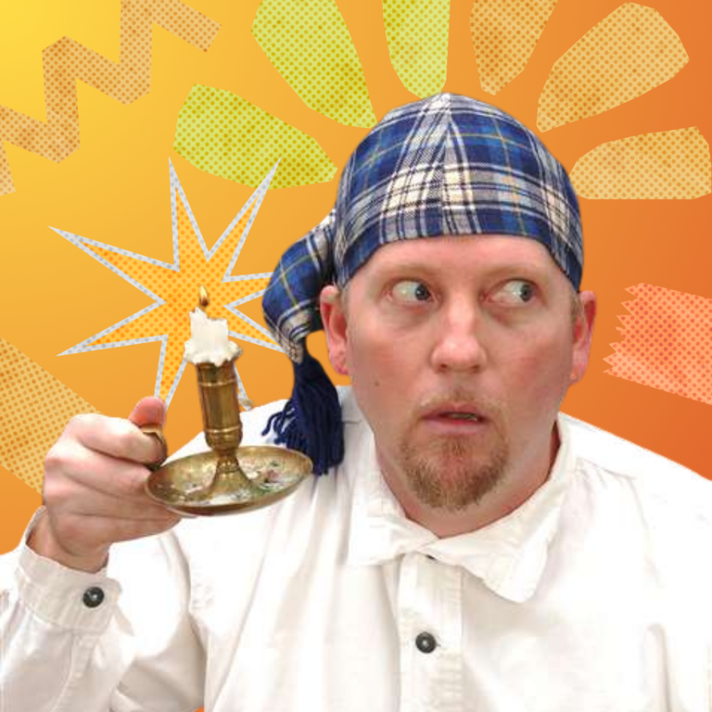 storyteller tim lowry holding a candle stick in his Christmas carol outfit